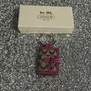 COACH signature with burgundy-ish trim and a heart hang tag. NWOT w/box